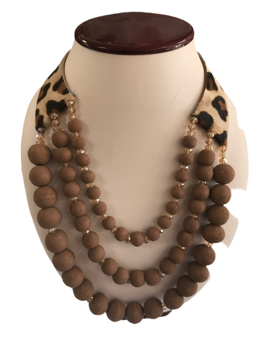 Multi layered wood necklace with faux leopard collar.