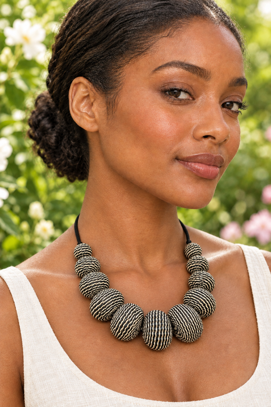 Recreated garden portrait of a woman wearing the black-and-cream woven necklace