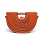Orange handbag with a unique design on a white background
