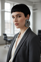 White model with black pixie haircut in office attire wearing the Nala zebra print statement earrings